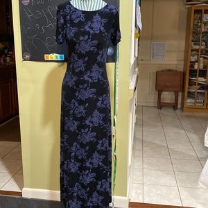 Short sleeved stretchy dress with blue floral print on black background.